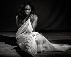 Quiet Form Black and white seated figure study of a woman draped in white fabric