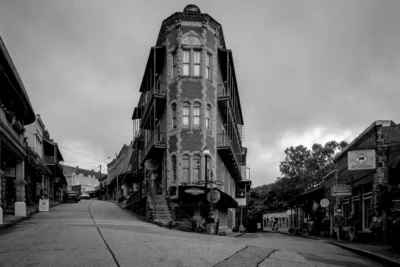 The Flatiron Building, Eureka Springs, Arkansas Black and white photograph of the Flatiron Building at a steep street intersection in Eureka Springs, Arkansas.