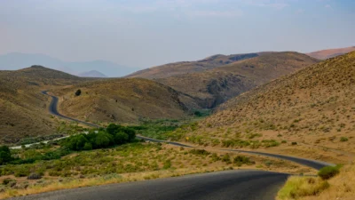 Silver City Road, Idaho Color photograph of Silver City Road winding through dry hills and desert landscape in Idaho.